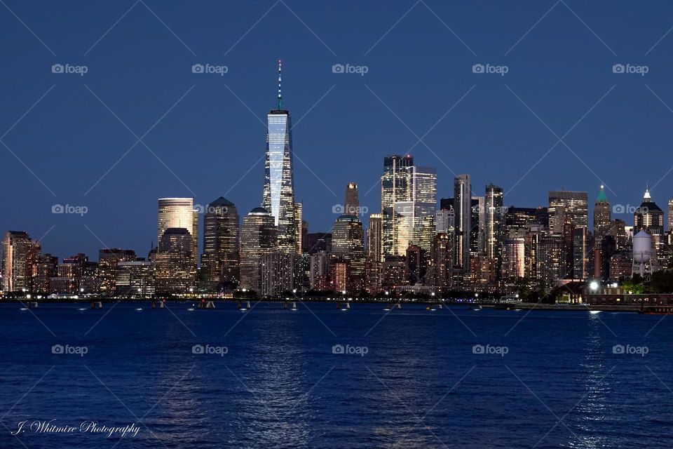 The gorgeous and iconic skyline of lower Manhattan showcases the Freedom Tower as well as many other historic architectural masterpieces