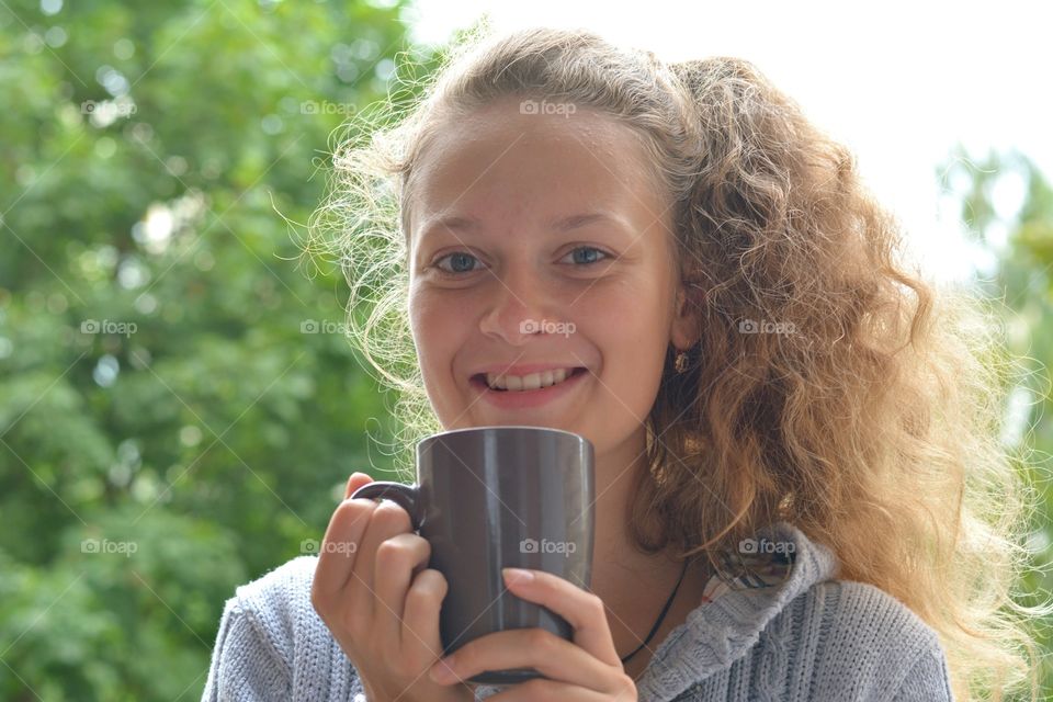 girl with cup of tea smiling beautiful portrait green background