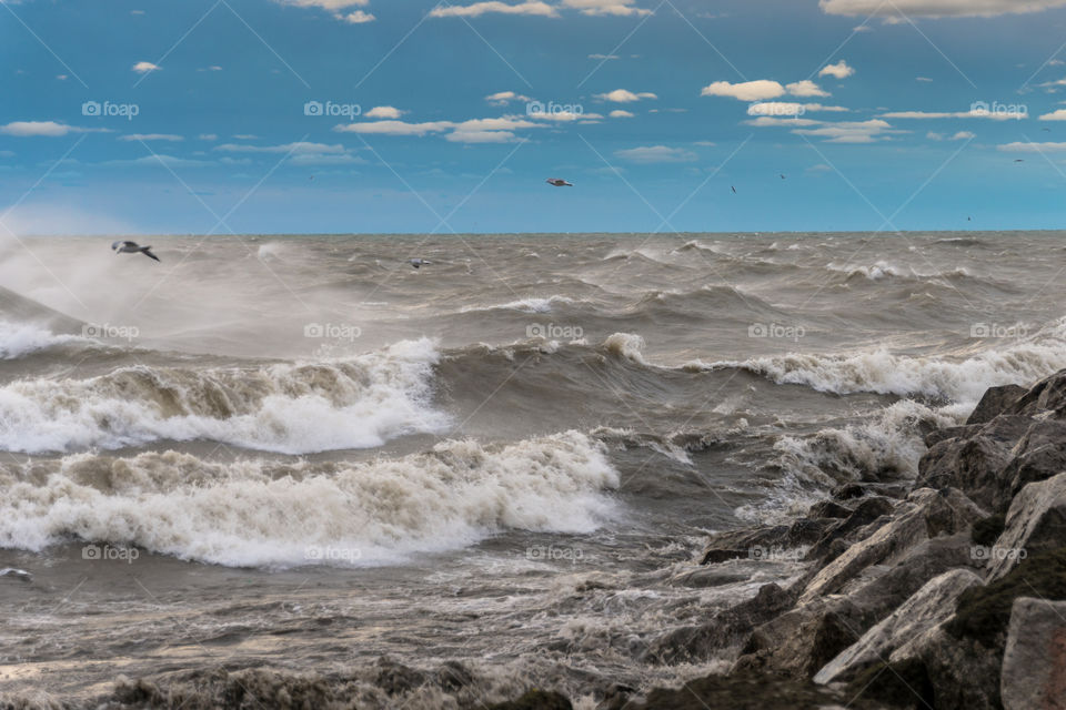 Crashing waves in Wisconsin. Large crashing waves on rocky shoreline of Lake Michigan in Milwaukee Wisconsin