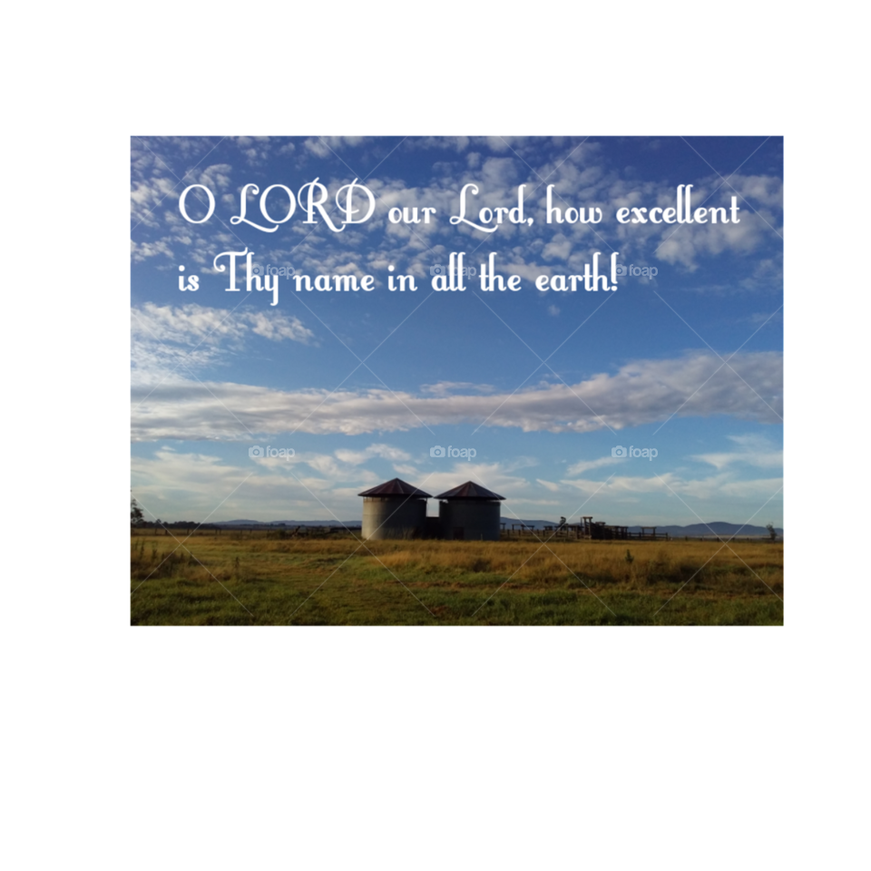 country scene of paddocks and grain silos cloudy sky and Bible verse