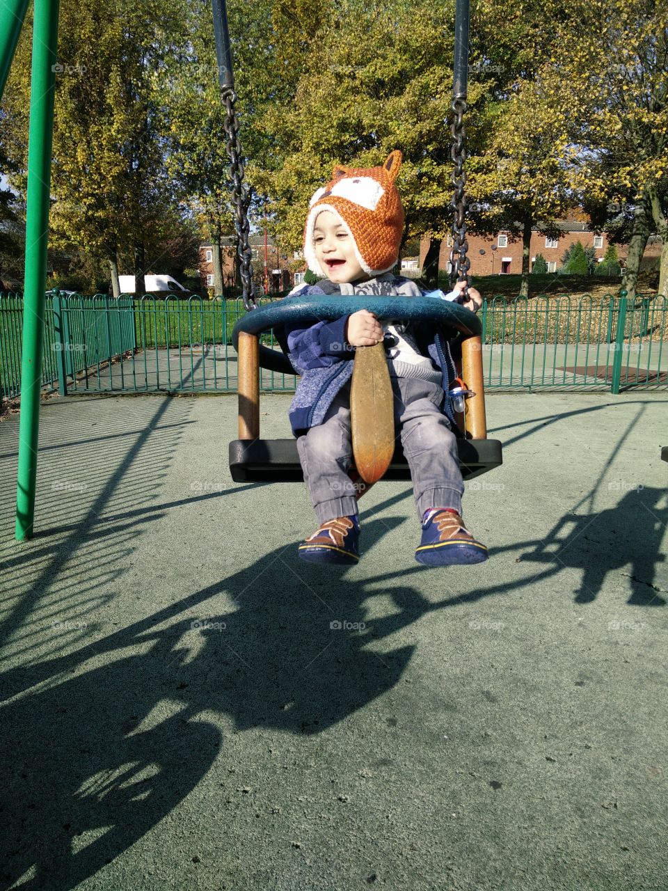 Small child playing on swing