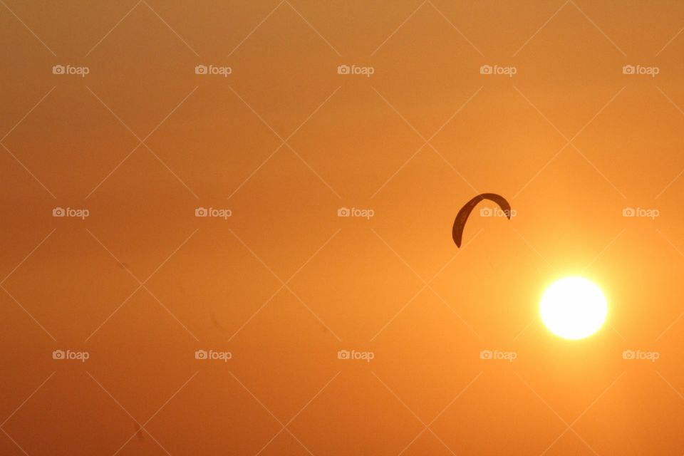 The beautiful orange and golden sunset. Playing around the parachute when it's going to the sea for a good night sleep. 