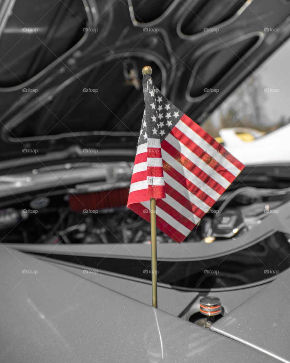 Small American Flag Seen Under Hood At a Classic Car Show