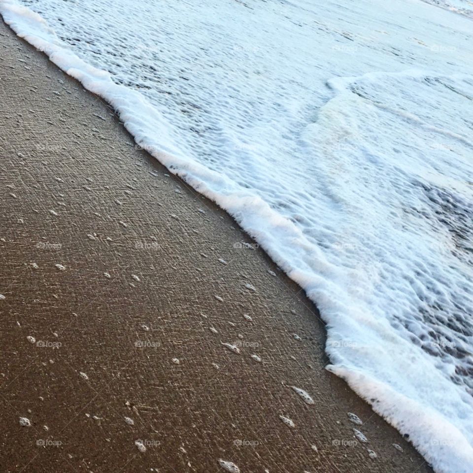 Foamy wave at the beach 