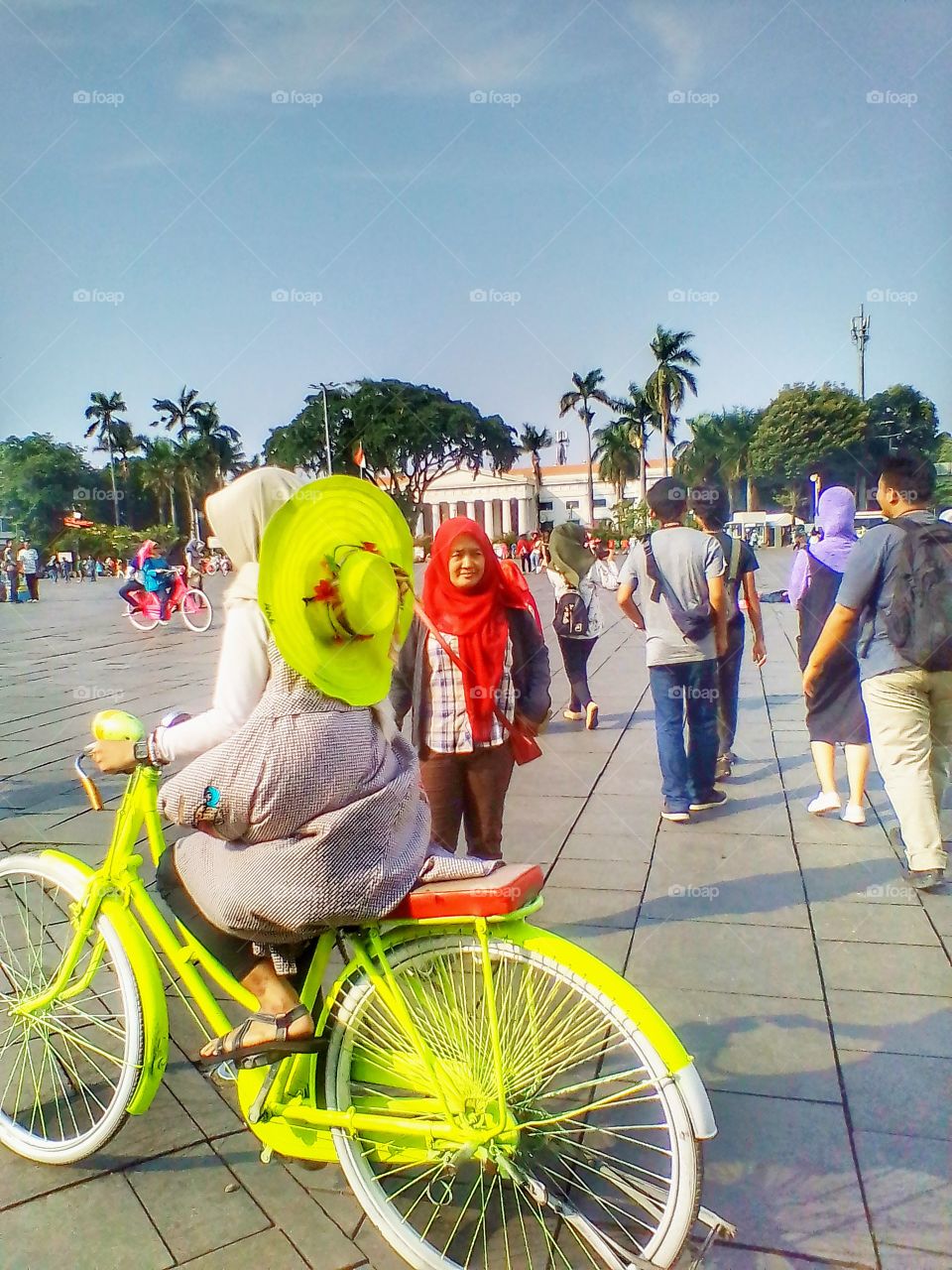 Playing bicycle in the courtyard of a white building in the old city of Jakarta, Indonesia