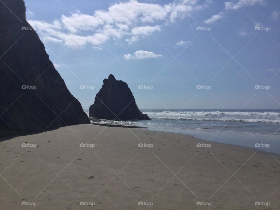 A Rock Formation in Distance Along the Beach at Hug Point in Oregon 