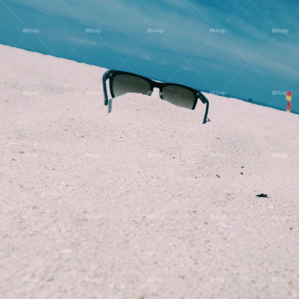 sunglasses on the white sand