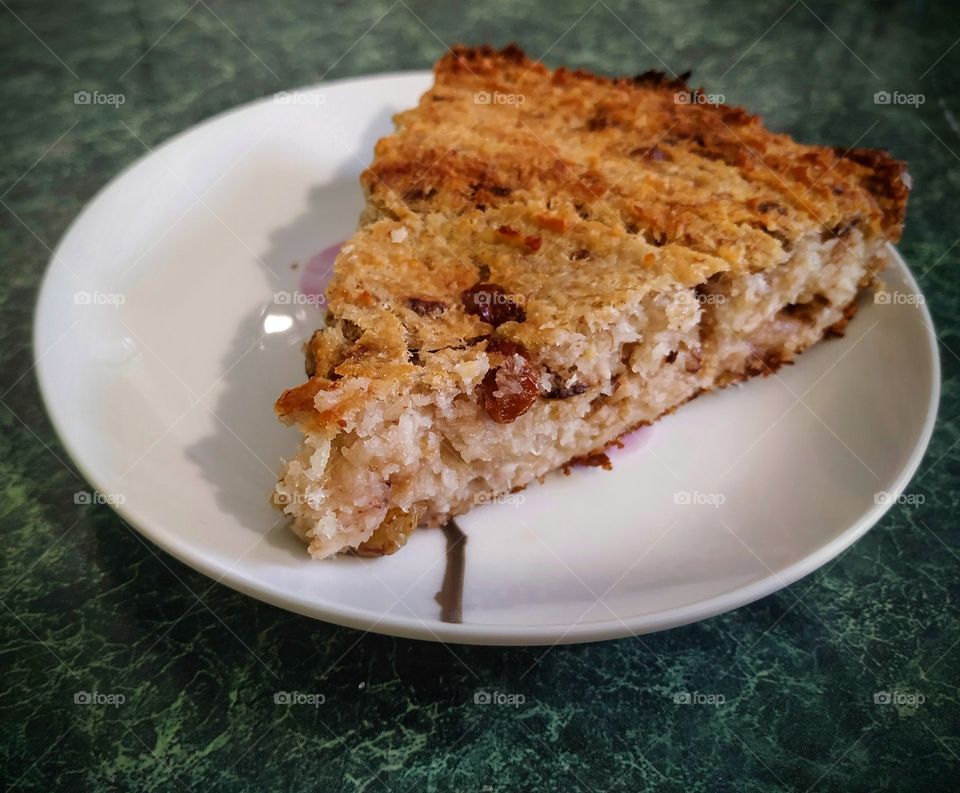 A piece of coconut cake with bananas