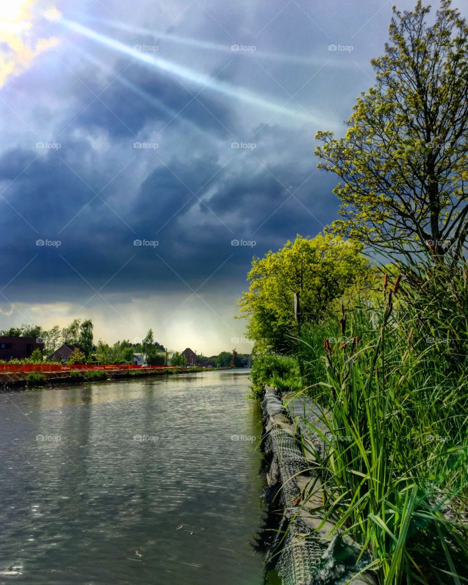 Sunset under a cloudy sky over the river