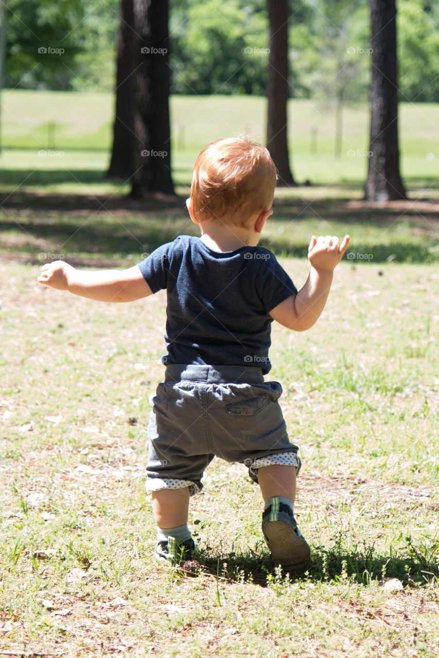 Rear view of a walking baby