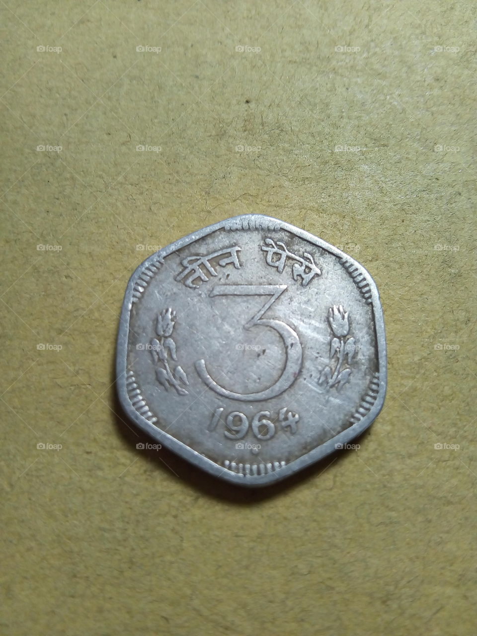 A coin of three paise- 1/33.33 share of Indian Rupee issued by Government of India in 1964.