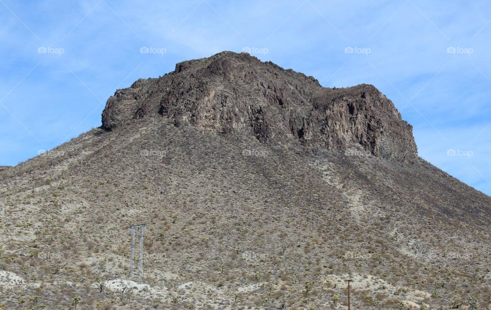desert mountains touching bright blue skies