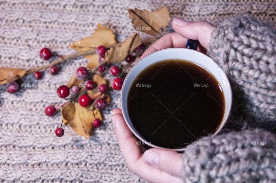 a cup of coffee in the winter in the hands of a girl