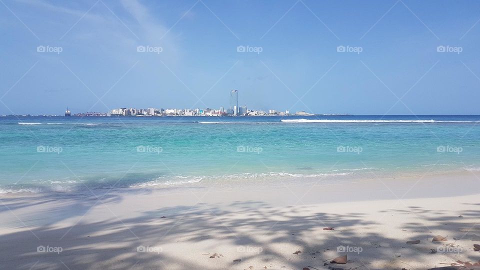 Male’, the capital of Maldives, is captured from a viligili, an adjacent island. White sandy beaches and crystal clear water of Maldives attract millions worldwide.