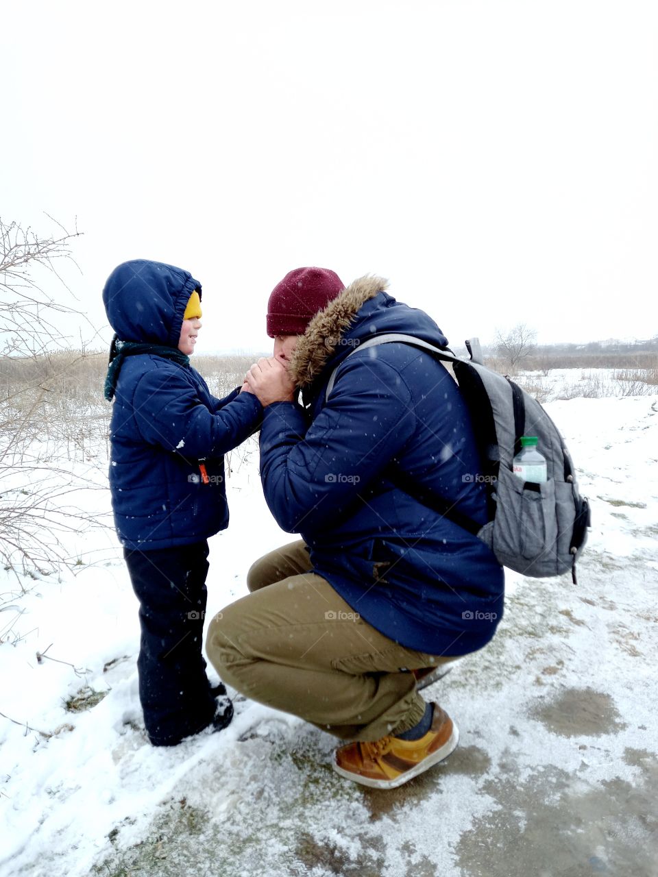 dad warms the baby's hands