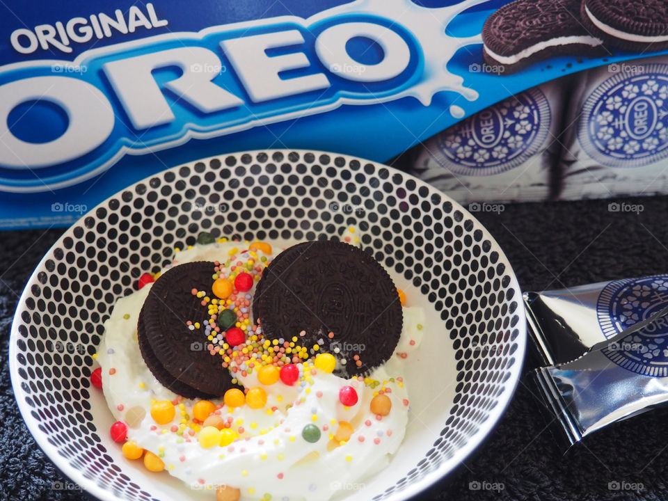 Oreo cookies with whipped cream and sprinkles.