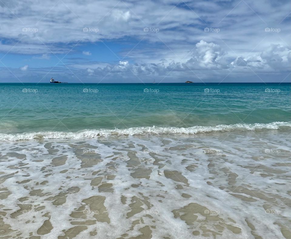 Waves rolling ashore on a beach in the Caribbean