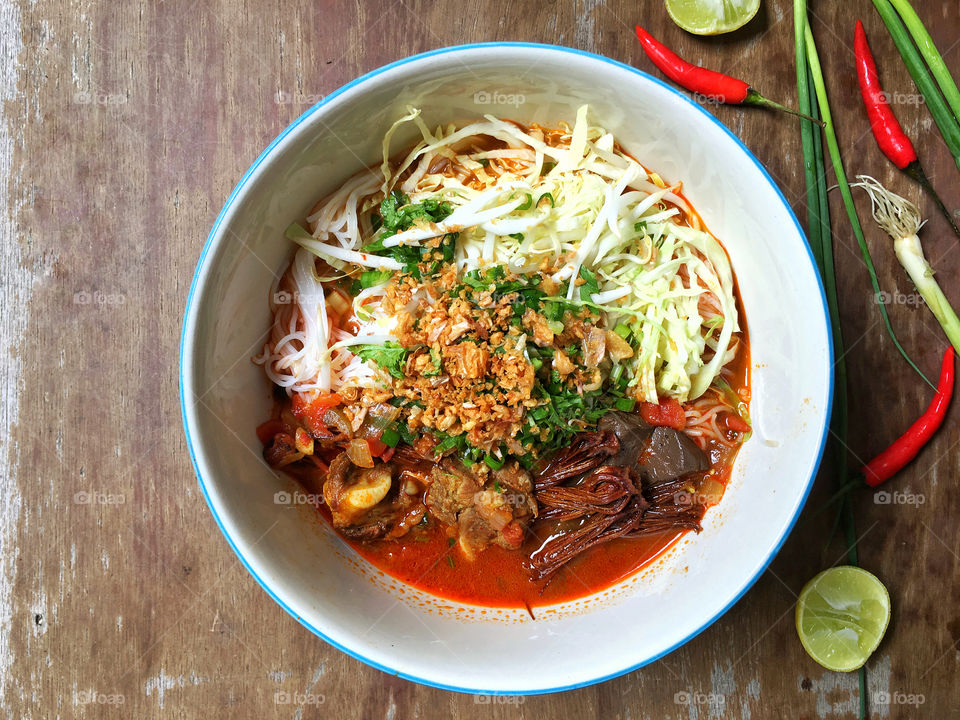 Northern Thai dish made from fermented rice noodles served with pork or chicken blood tofu in a spicy sauce made with pork broth and tomato, crushed fried chilies and dried red kapok flowers.