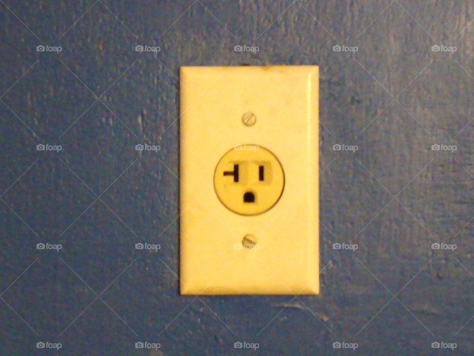 Wall Outlet around a Painted Blue Wall