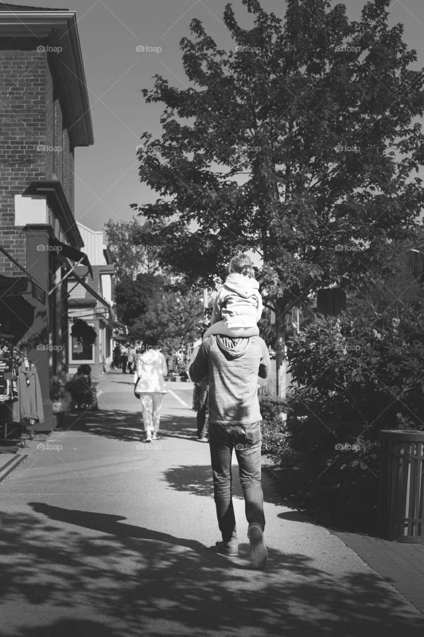 A father's love. Father and daughter strolling down the street