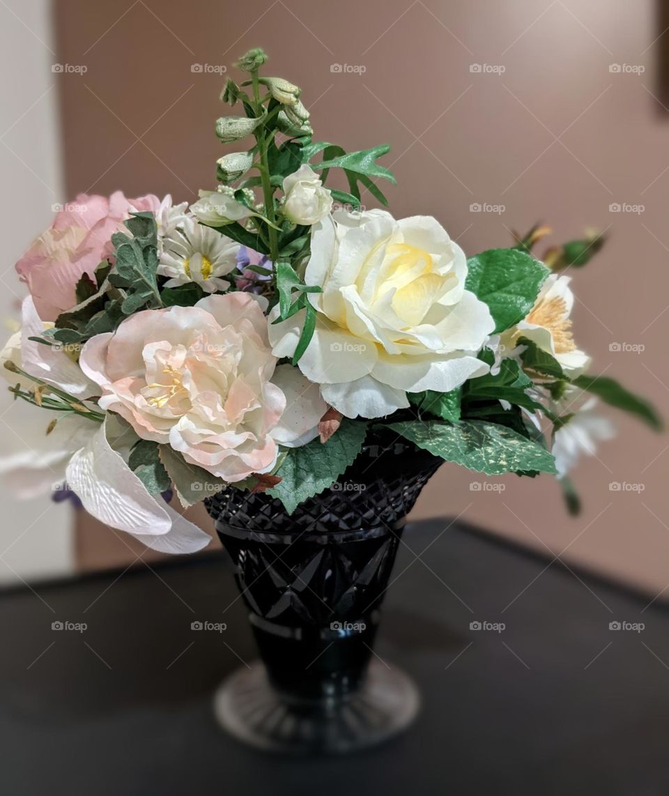 mixed flowers in an amethyst mistakes vase can