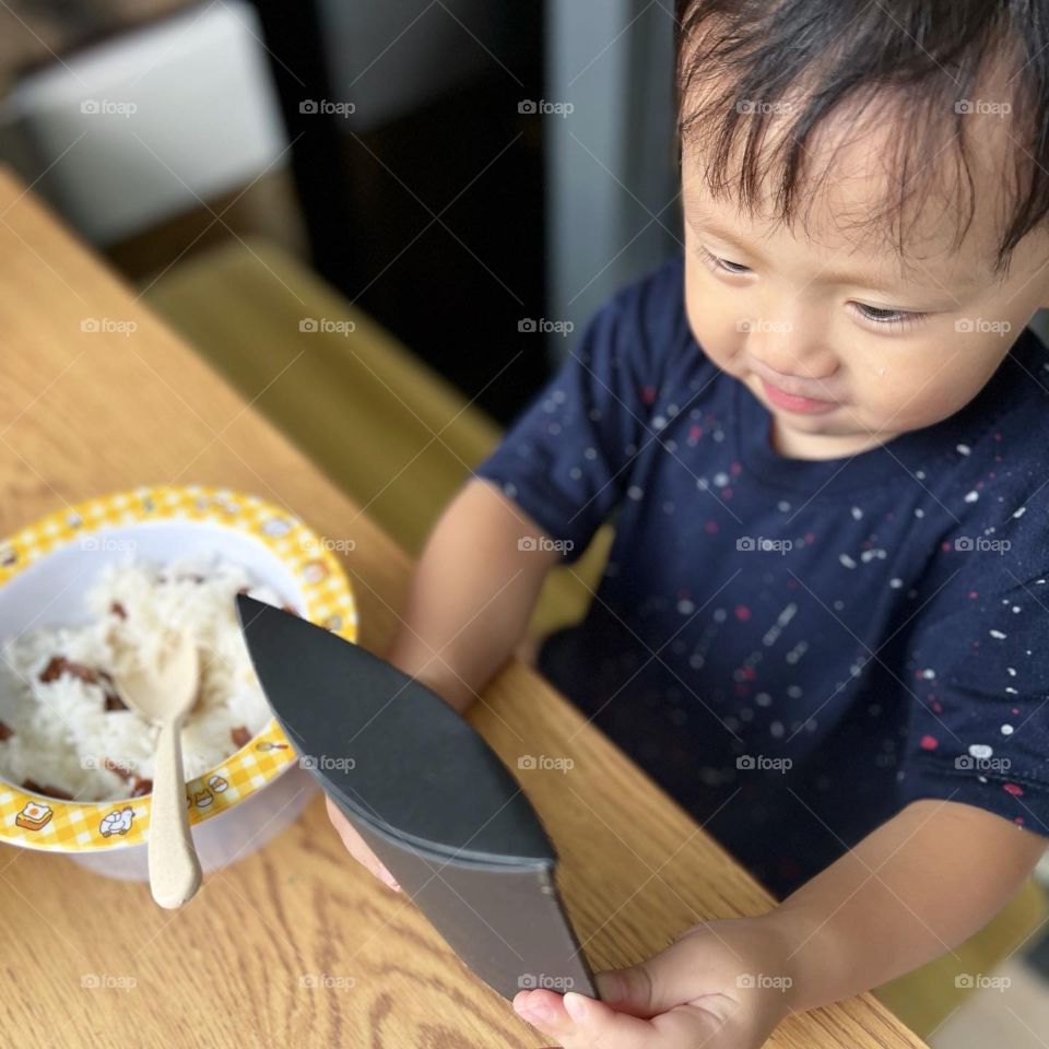 Asian kid trying out Tasty homemade Chicken grilled jerky 