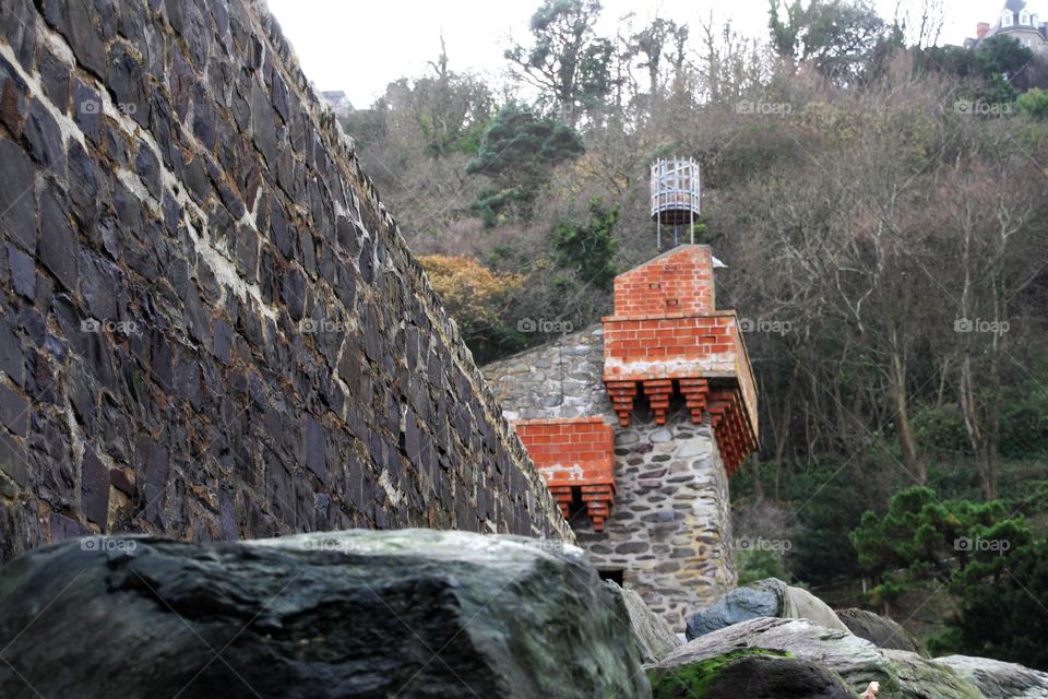 looking up from the beach to the salt water store and beyond up the cliff