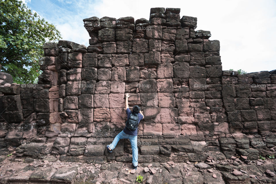 Boy climbing the old wall