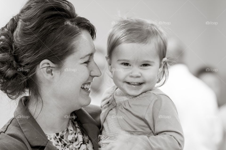 Mother Holding Small Girl with Big Smiles