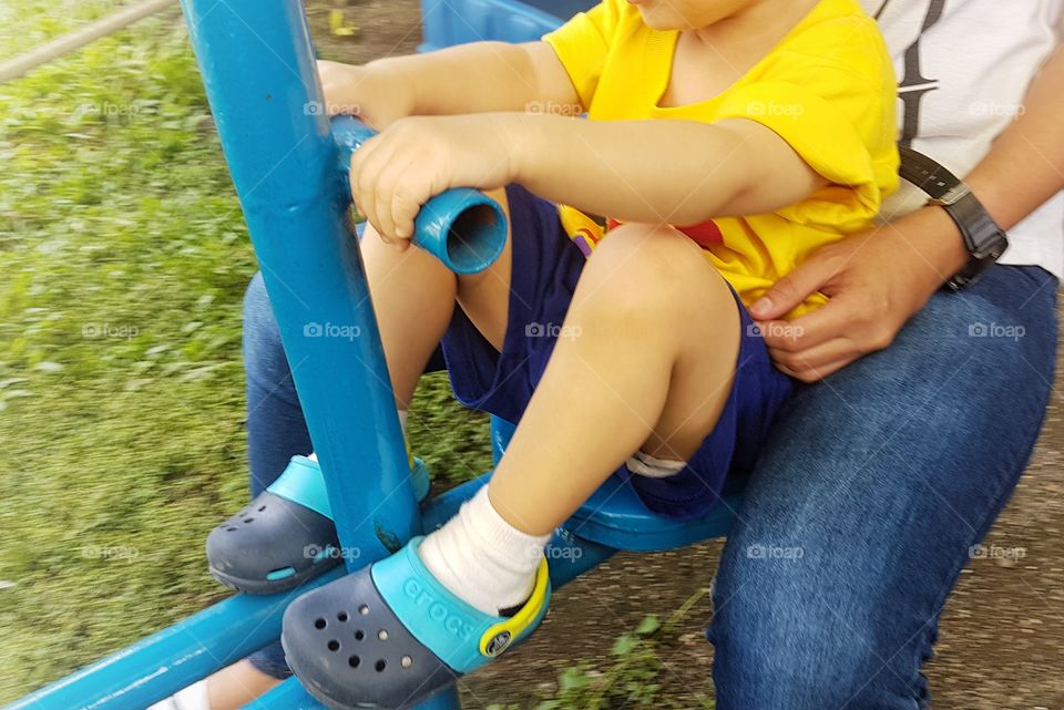 toddler swinging in playground