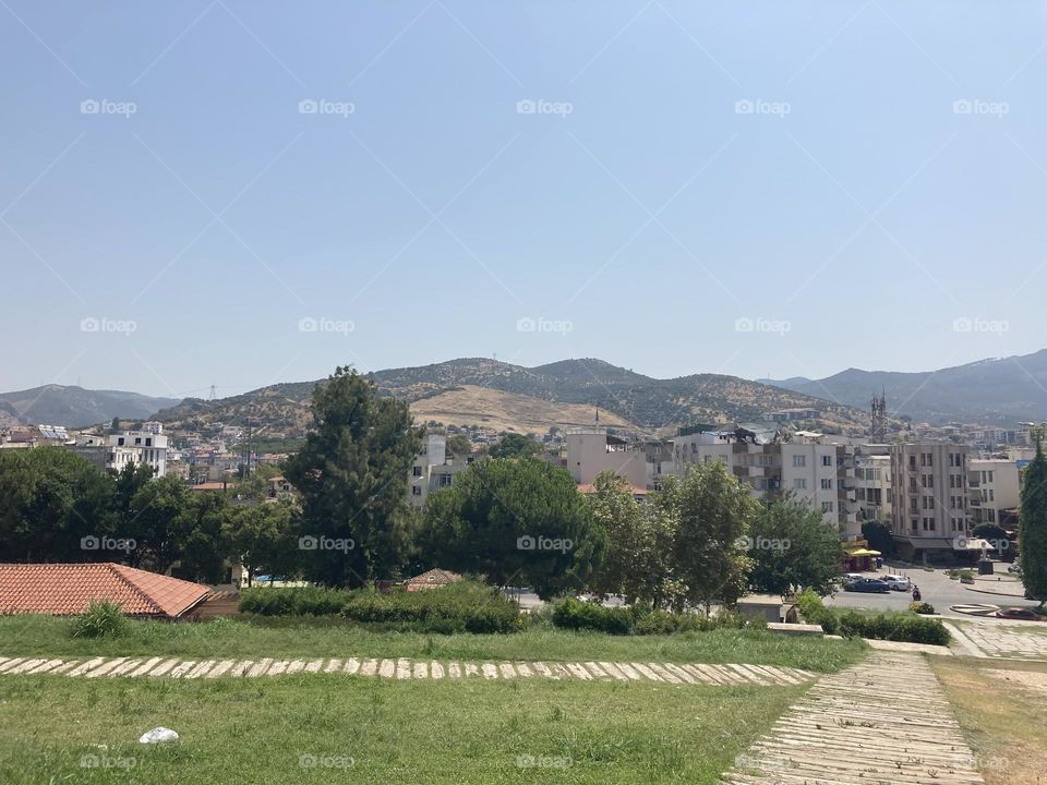 Sunny holidays I’m Turkey. Walk in the cute city and charming streets by the beach in Kusadasi. perfect blue sky and ocean view. Beach and the shore. To travel is to live. Gorgeous tall palm trees.