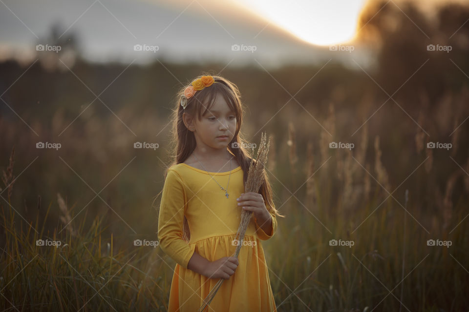 Little girl in yellow dress outdoor portrait 