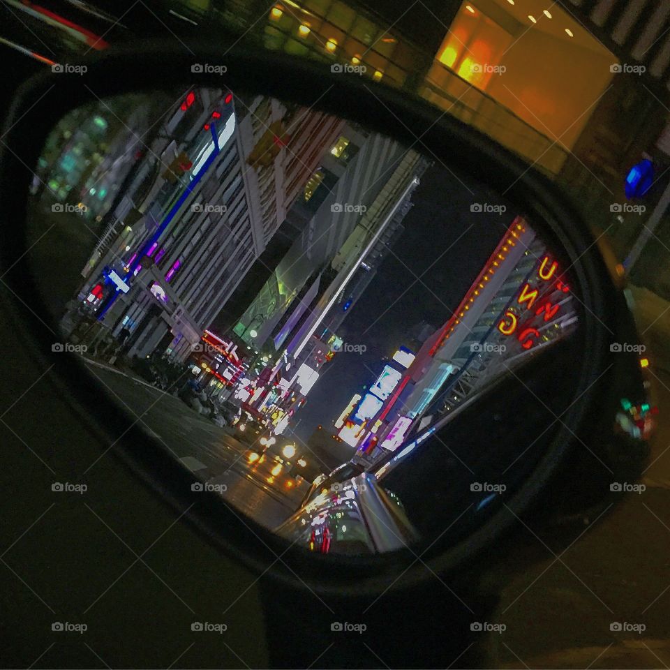 Times Square in rear view mirror.