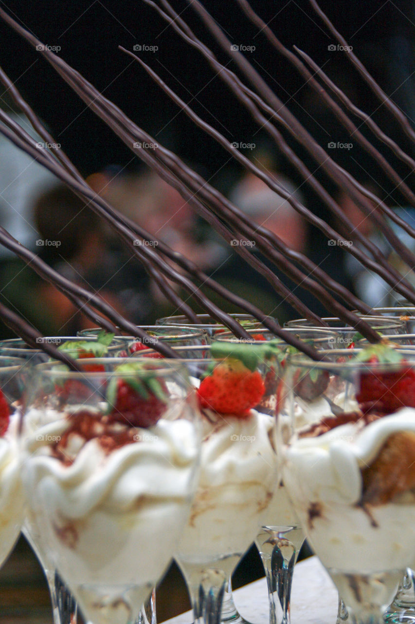 Single servings of tiramisu in wine glasses at an event