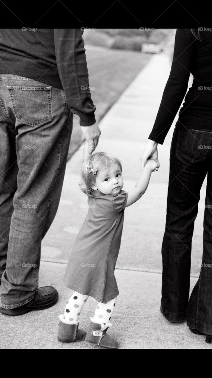 Little girl walking with her family