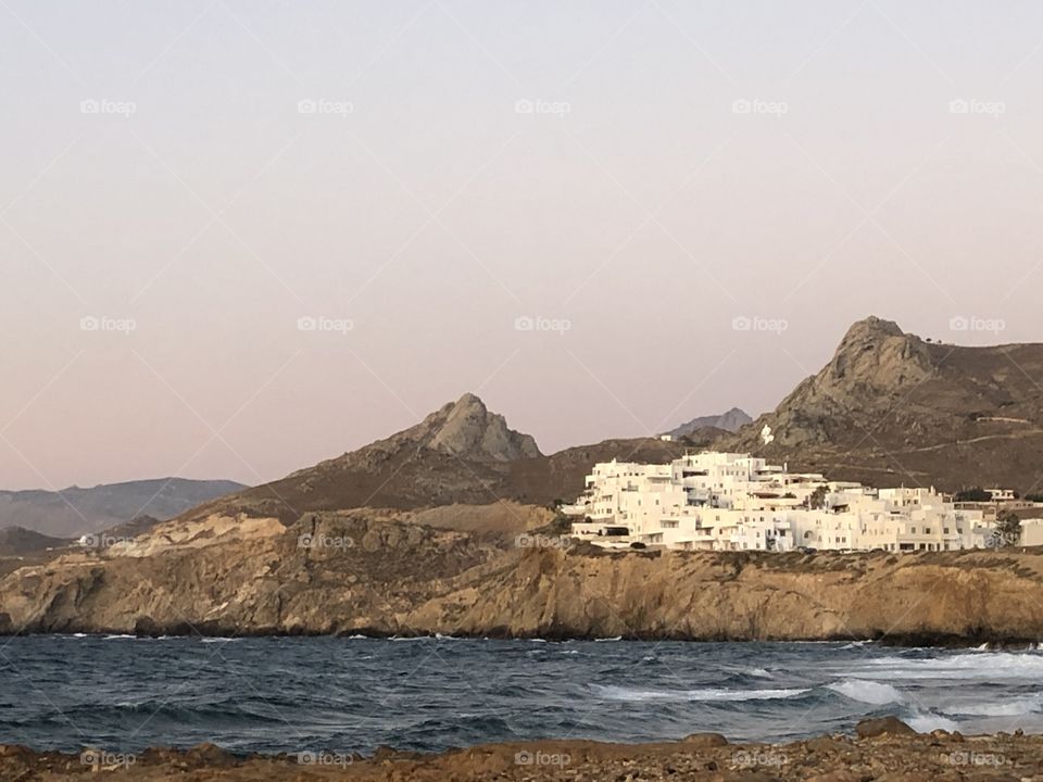 White washed Greek Village, pale pink sunset Paros 