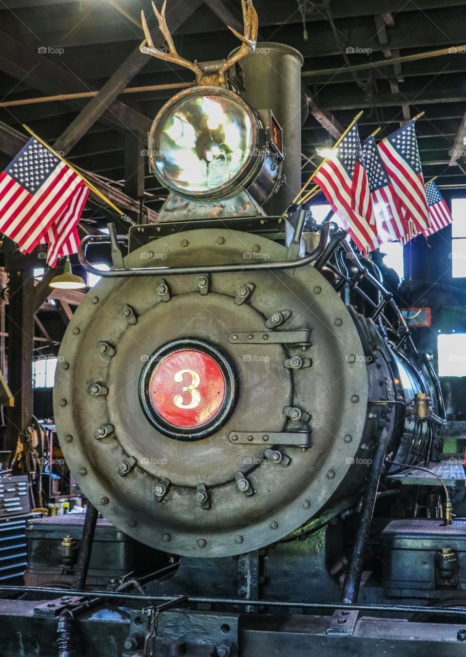 Train Engine #3 getting all dressed up in American flags for a 4th of July parade 