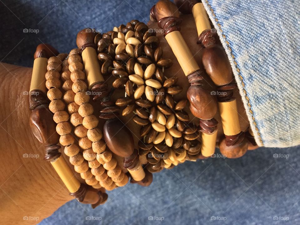 Showing my natural handmade bracelets of wooden beads, coffee beans and seeds.