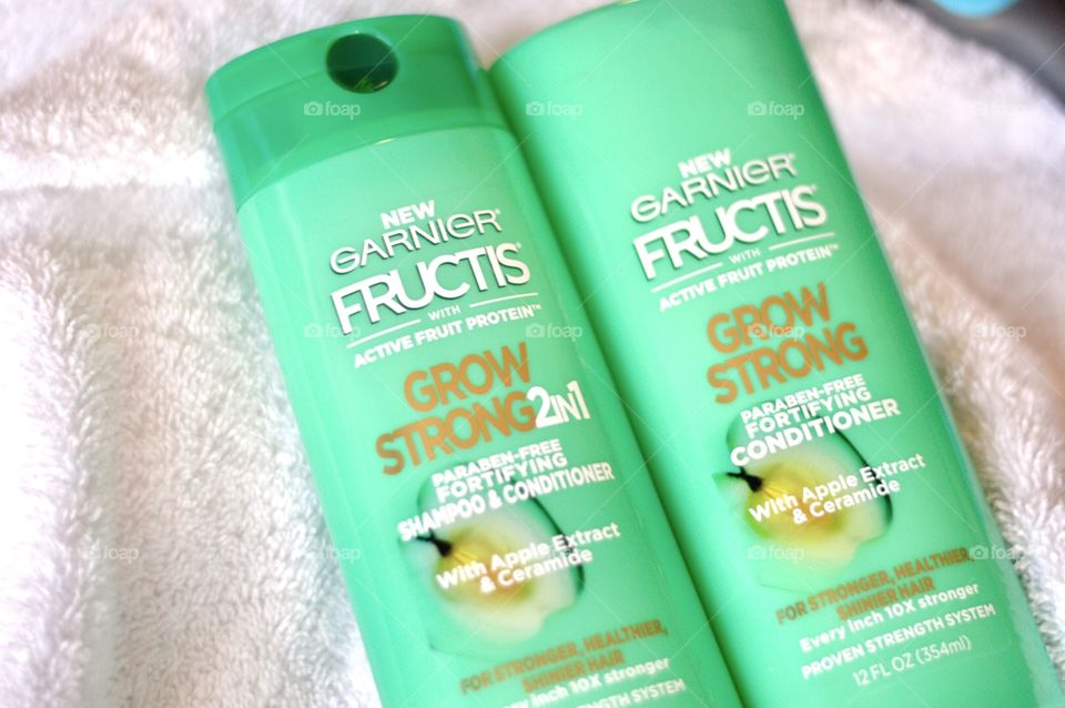 Garnier shampoo and conditioner on a white towel