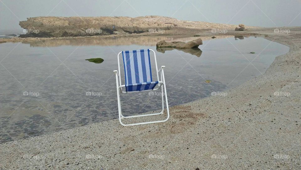 My beautiful blue chair near the beach.