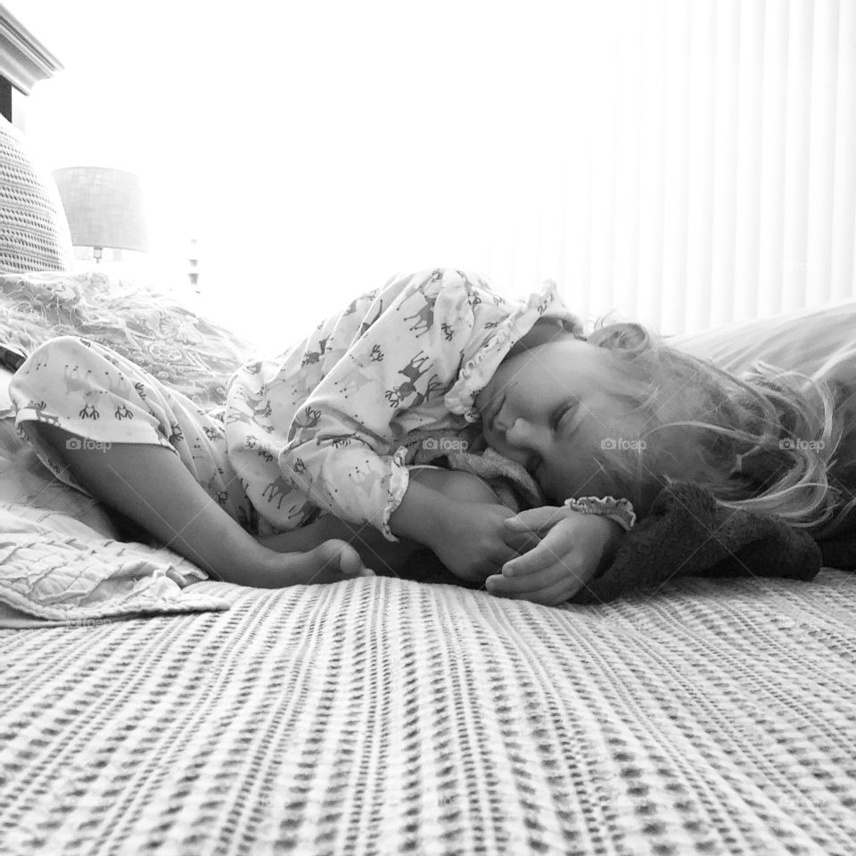 Sleeping baby at nap time in an awkward position doing sleep yoga 