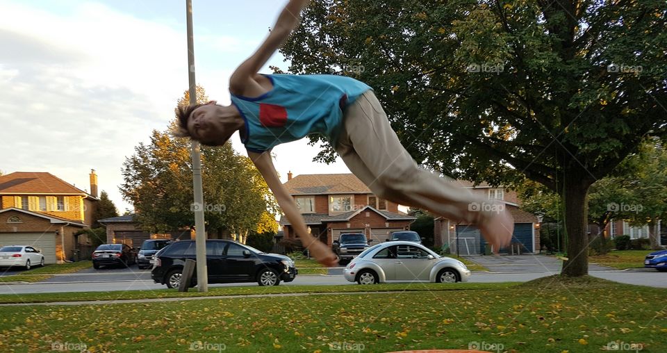 boy doing acrobatics in mid air