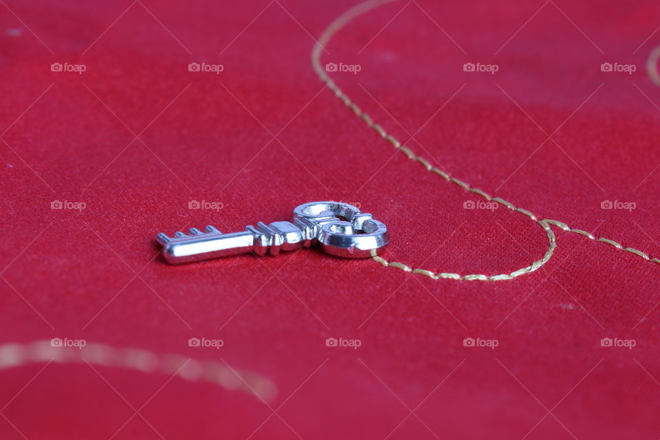 miniature key on red background