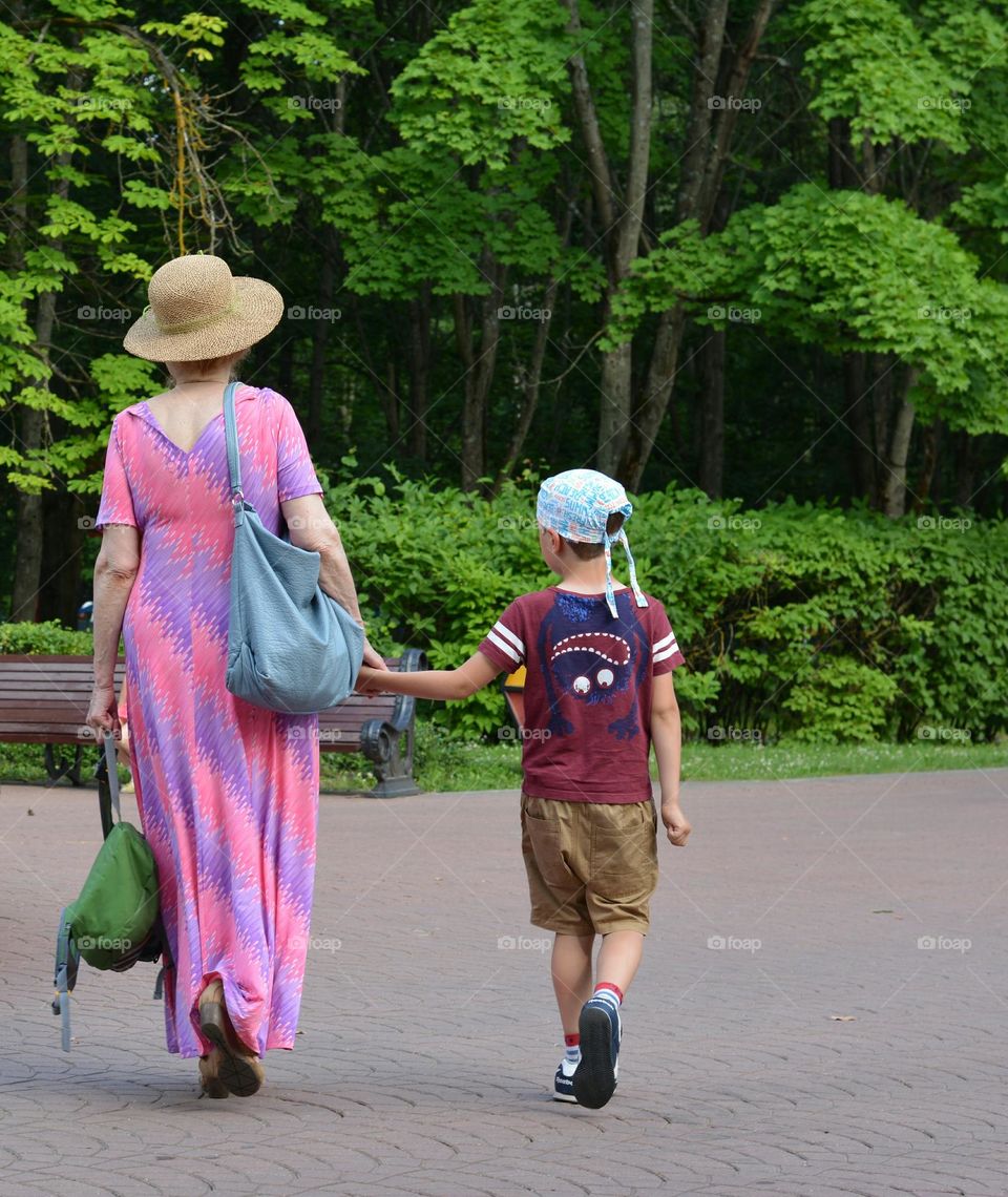 summer in the city, people family walking in city park