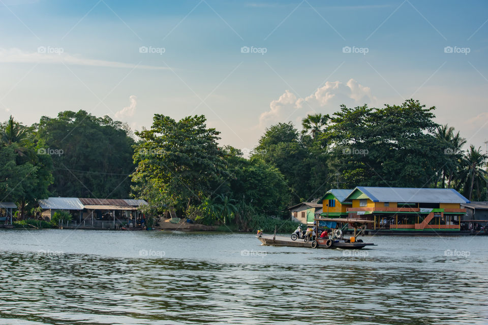 Ship passenger and motorbikes across  Khwae Noi river at Kanchanaburi Thailand.