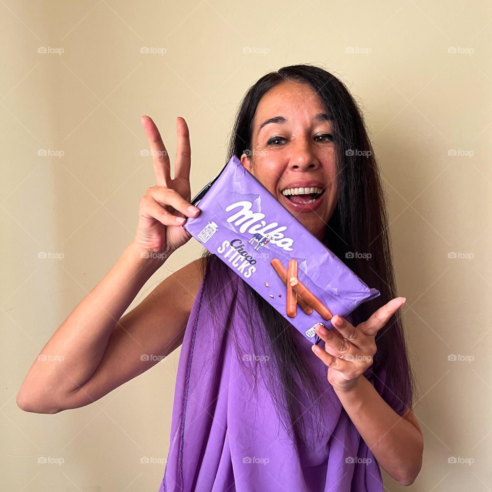 Energetic, Light-Hearted Portrait of Beautiful Smiling Woman with Milka Chocolate Sticks