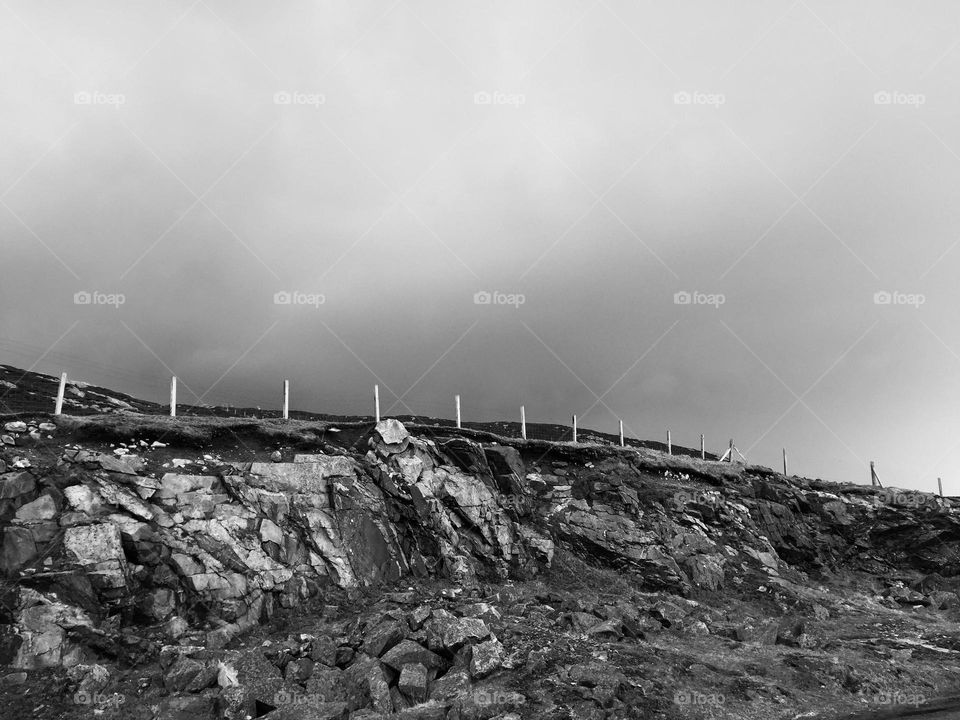 Black and white landscape of Scotland, fence line in Scotland, into the skies, wide open spaces