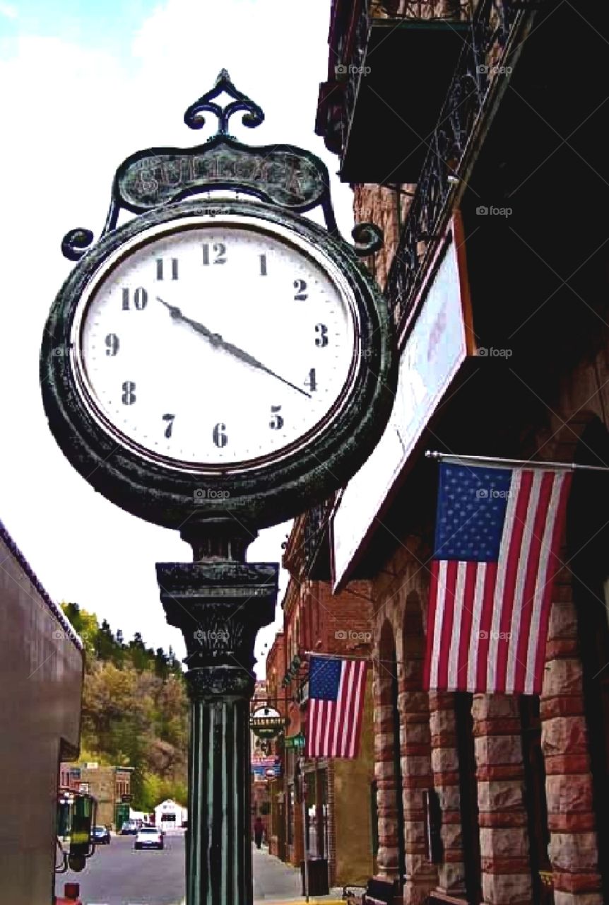 Flags along a street, clock