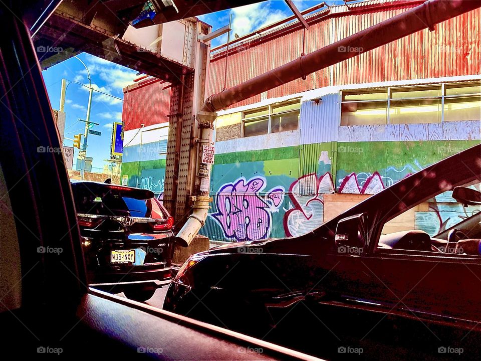 A colorful view of Long Island City, Queens, New York seen from a car window while driving home to Newtown Creek and our boat, the “Salvation” on a bright sunshiny afternoon in November of 2021. Hypnotic Productions