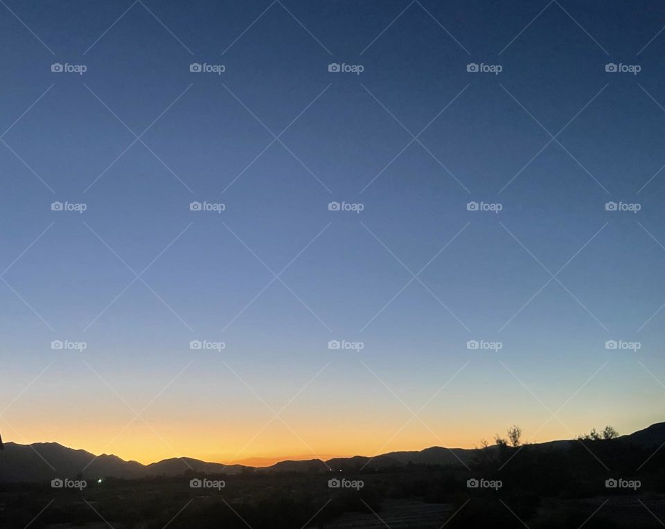 A colorful yellow sunset with mountains. 